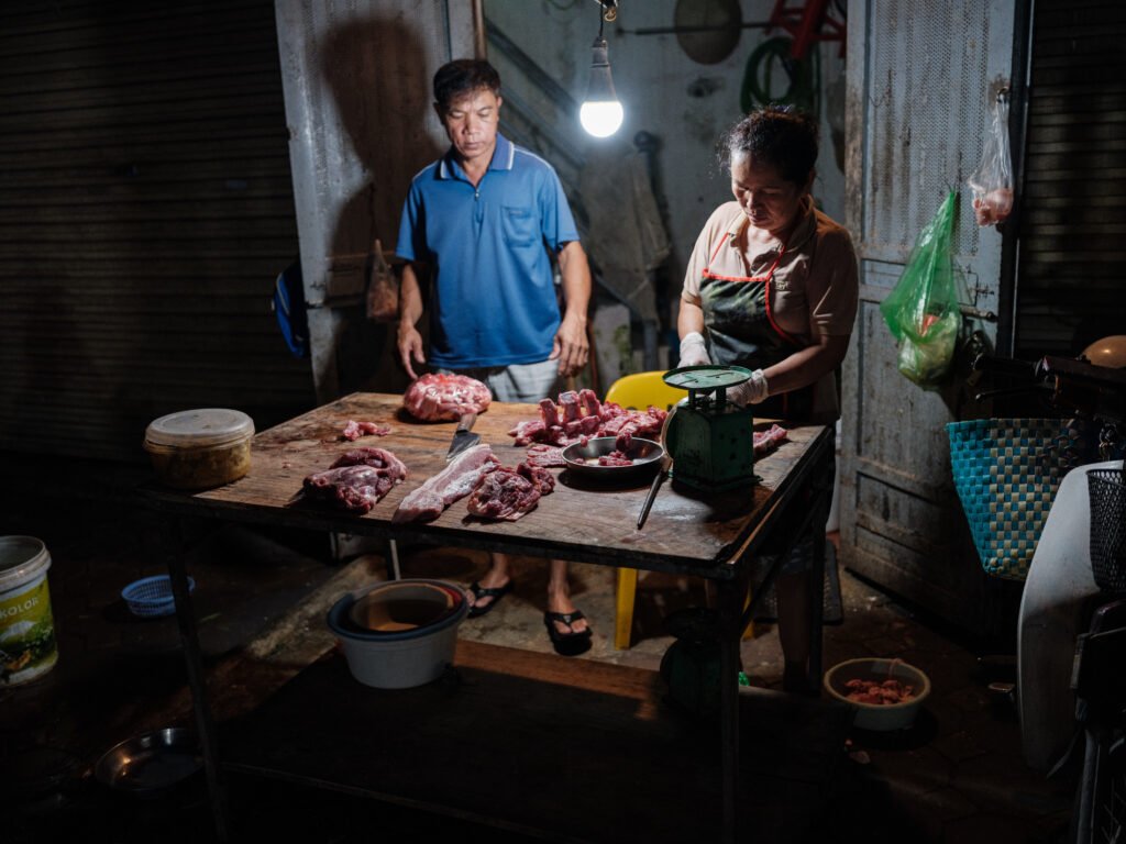 Meat Merchants at night in Hanoi, Vietnam